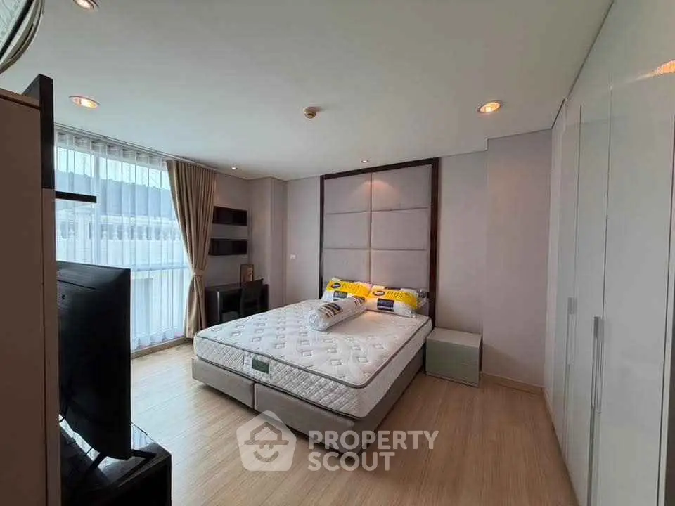 Spacious modern bedroom with large windows and elegant decor
