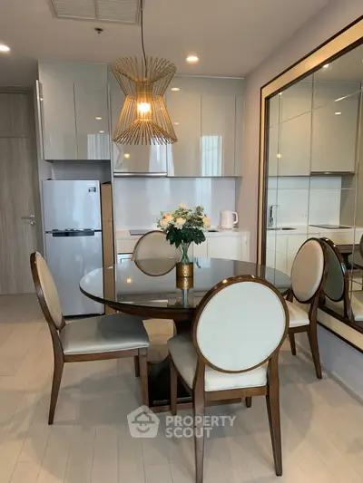 Elegant dining area with modern decor and stylish lighting in a contemporary apartment.