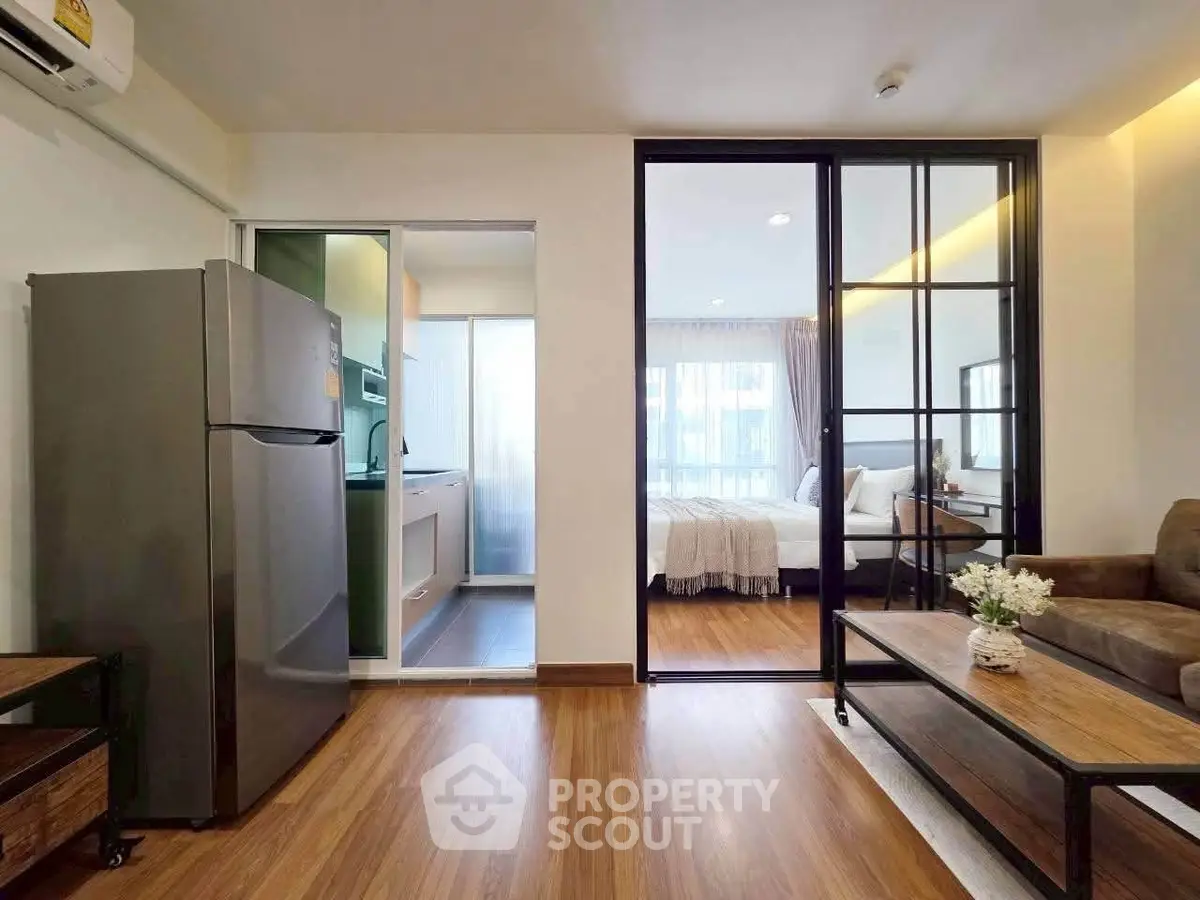 Modern apartment with open layout, featuring a cozy living room, sleek kitchen, and inviting bedroom.