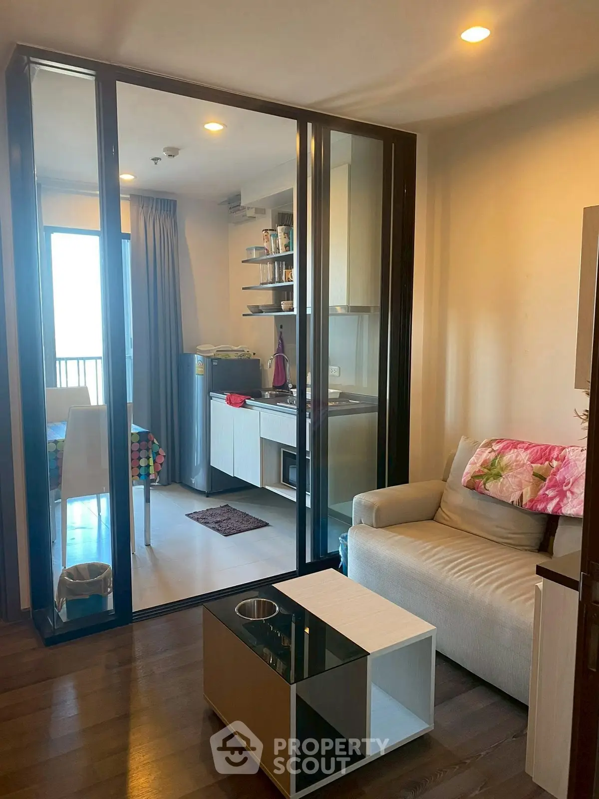 Modern living room with glass partition and cozy seating area