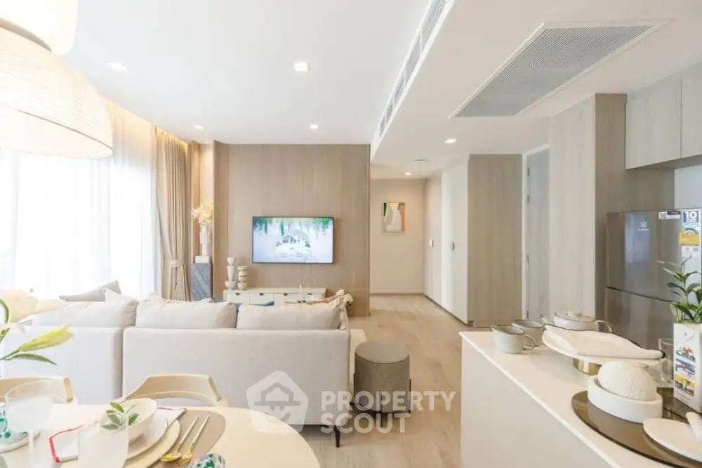 Modern open-plan living room with stylish decor and natural light