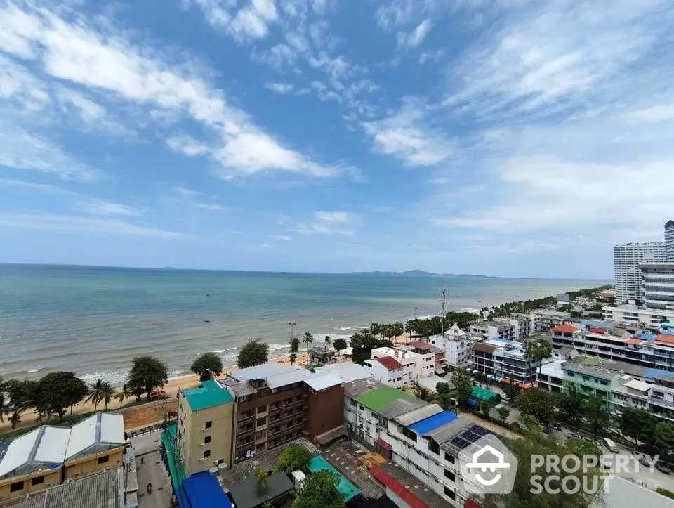 Stunning coastal view from high-rise building overlooking ocean and cityscape.