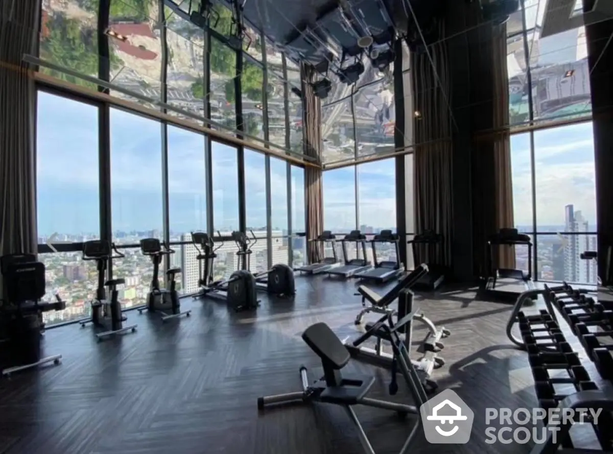 Luxurious high-rise gym with panoramic city views and modern fitness equipment.