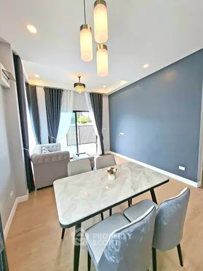 Modern living room with elegant dining area and stylish lighting