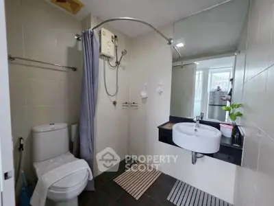Modern bathroom with sleek fixtures and a spacious shower area, perfect for relaxation and comfort.