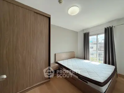 Modern bedroom with wooden wardrobe and large window for natural light