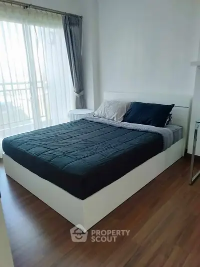 Modern bedroom with large window and stylish decor
