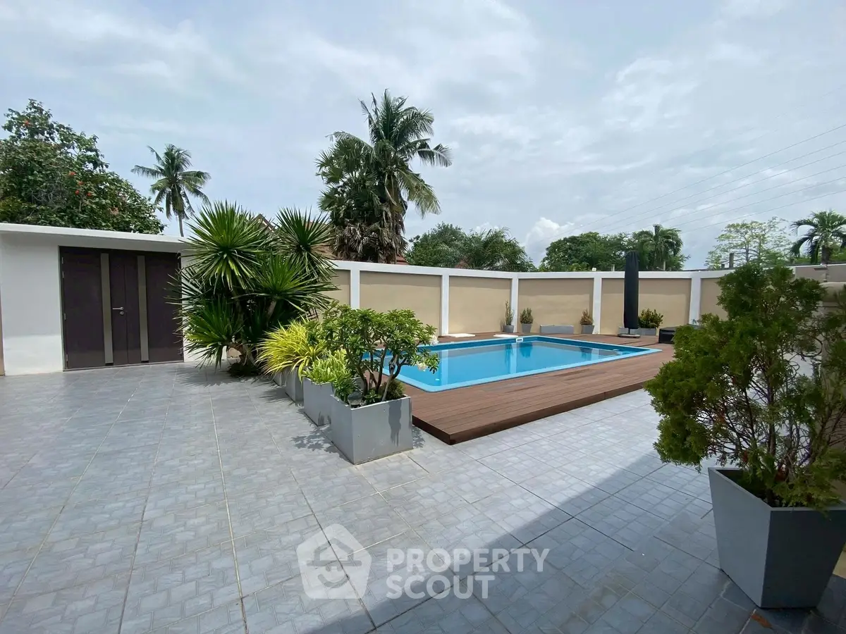 Stunning outdoor pool area with lush greenery and modern design.