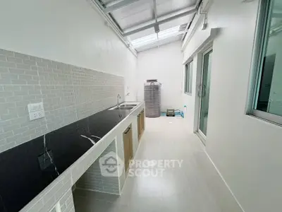 Modern kitchen with sleek countertops and ample natural light