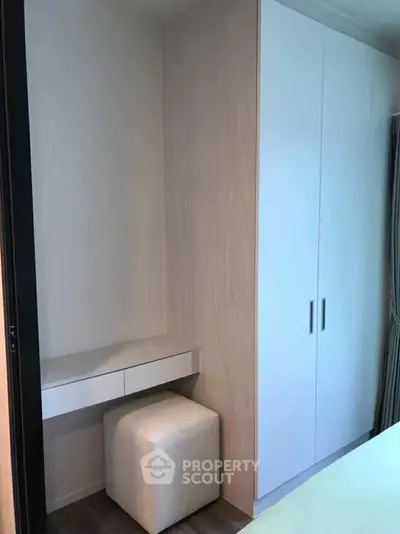 Modern bedroom with sleek wardrobe and compact dressing area