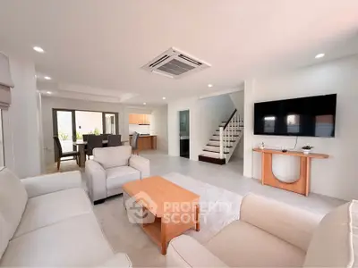 Spacious modern living room with elegant furniture and open layout in a luxury home.