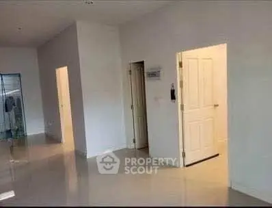 Spacious modern interior with glossy floors and open doors, perfect for customization.