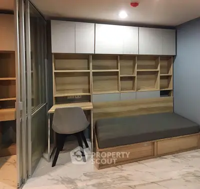 Modern study room with built-in shelves and sleek furniture design.