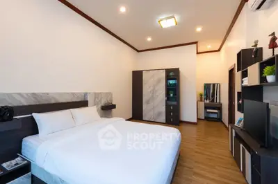 Spacious modern bedroom with elegant decor and ample storage space.