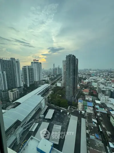Stunning cityscape view from high-rise building at sunset, showcasing urban skyline and vibrant city life.