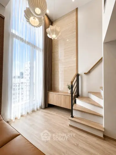 Stunning modern living room with high ceilings and elegant staircase