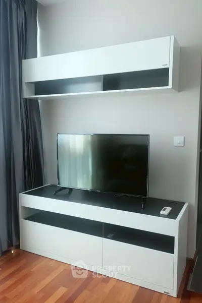 Modern living room with sleek TV stand and wall-mounted cabinet