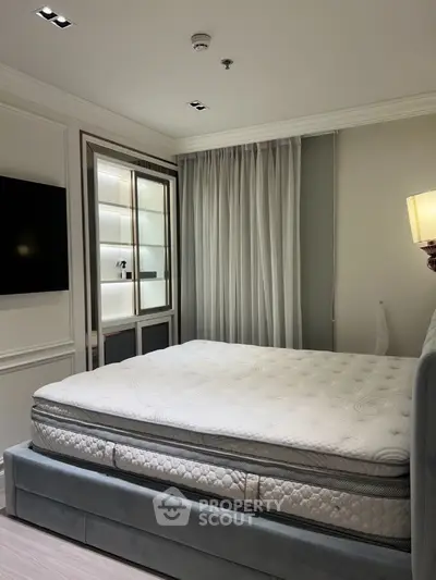 Luxurious bedroom with plush mattress and elegant lighting