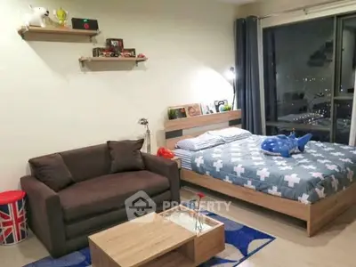 Cozy bedroom with city view, modern decor, and comfortable seating area.