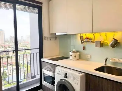 Modern kitchen with city view, featuring sleek appliances and ample storage space.