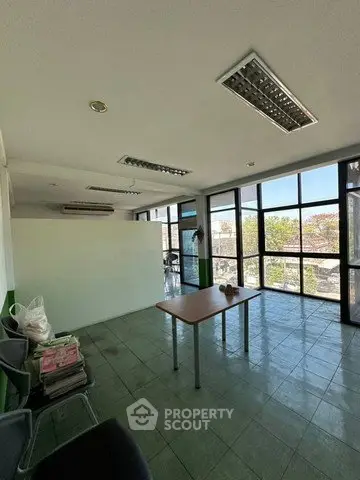 Spacious office space with large windows and natural light