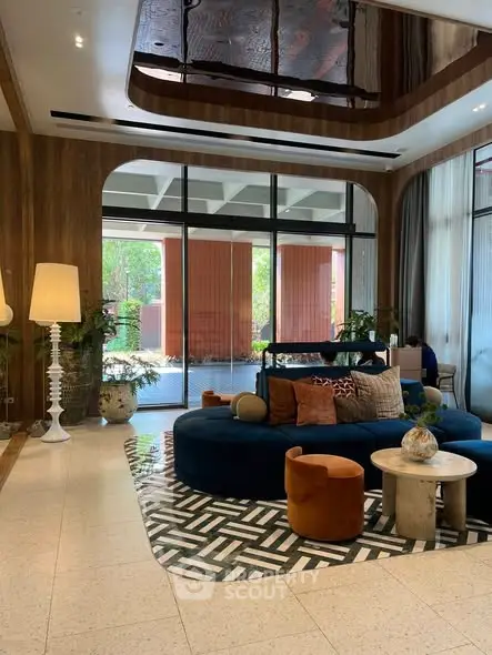 Luxurious living room with modern decor and large windows overlooking a serene garden view.