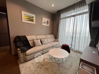 Modern living room with cozy sofa, stylish decor, and large window offering natural light.