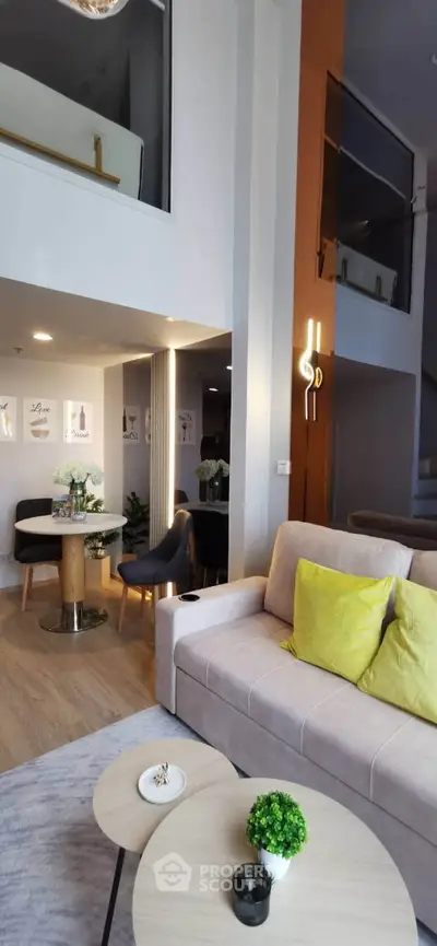 Modern duplex living room with stylish decor and open layout, featuring a cozy sofa and elegant dining area.