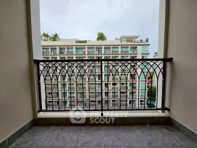 Charming balcony view overlooking modern apartment building, perfect for urban living.