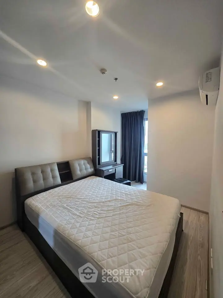 Spacious bedroom with modern furnishings and natural light, perfect for comfortable living.