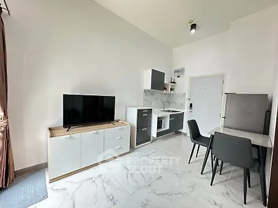 Modern studio apartment with sleek kitchen and cozy dining area