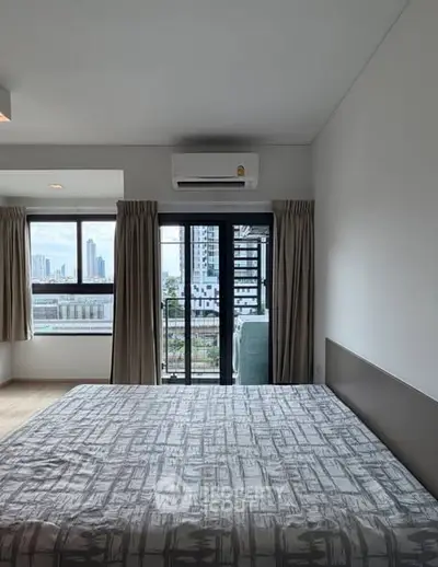 Modern bedroom with city view and air conditioning, featuring a large window and stylish decor.