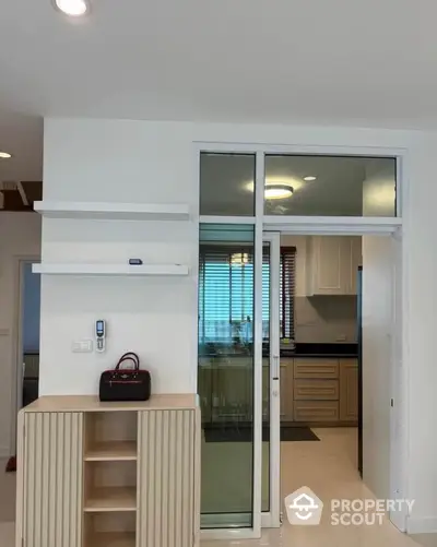 Modern kitchen with sliding glass door and sleek cabinetry