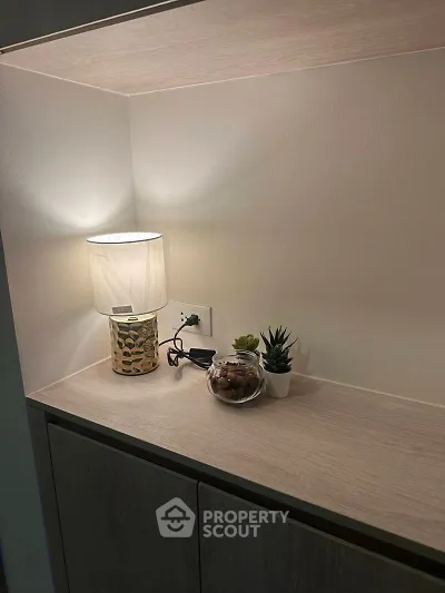 Modern interior shelf with stylish lamp and decorative plants