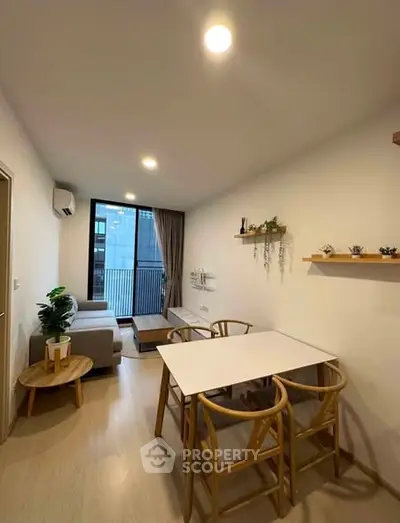 Modern living room with stylish furniture and balcony view in a cozy apartment.