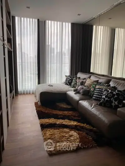 Stylish living room with modern decor and large windows offering city views.