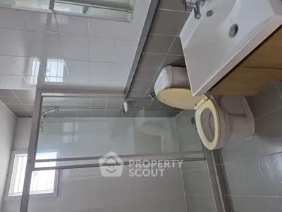 Modern bathroom with glass shower and sleek fixtures, ideal for contemporary living.