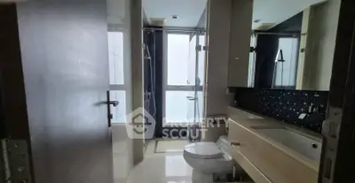 Modern bathroom with sleek fixtures and glass shower enclosure
