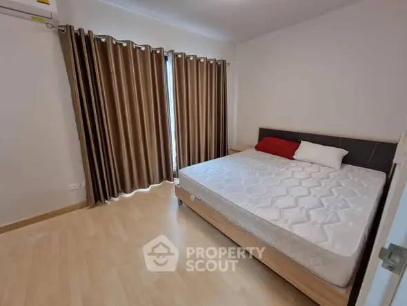 Spacious bedroom with large window and modern decor