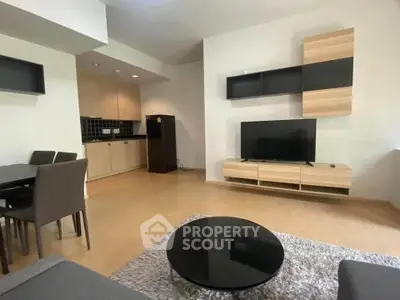 Modern living room with sleek furniture and open kitchen layout