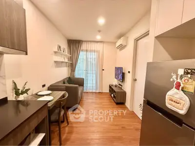 Modern living room with cozy sofa, TV, and dining area in stylish apartment.