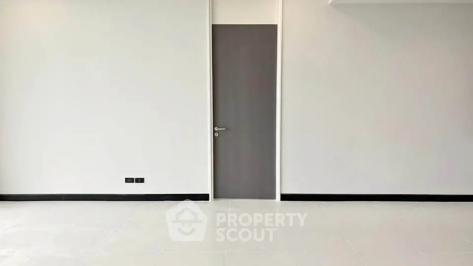 Minimalist interior with sleek door and pristine white walls