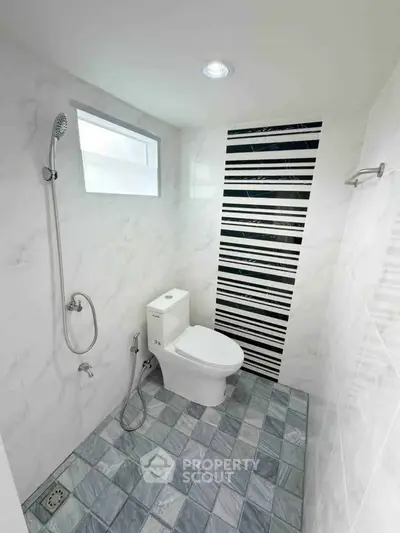 Modern minimalist bathroom with sleek design and stylish tile accents.