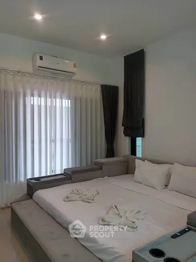 Spacious bedroom with modern decor and natural light