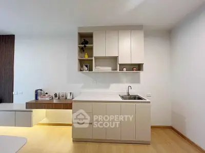 Modern minimalist kitchen with sleek cabinetry and integrated sink, perfect for contemporary living.