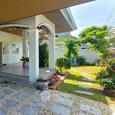 Charming garden view with lush greenery and elegant entrance pathway