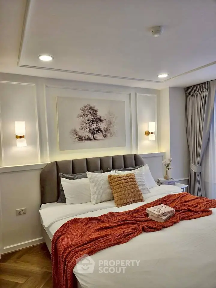 Luxurious bedroom with elegant decor and cozy ambiance, featuring plush bedding and stylish lighting.