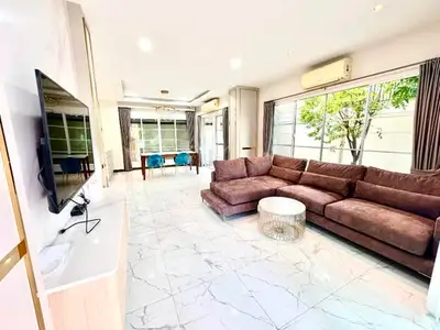 Spacious modern living room with large windows and stylish furniture