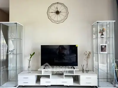 Modern living room with sleek TV stand and glass display cabinets, perfect for stylish home entertainment setup.