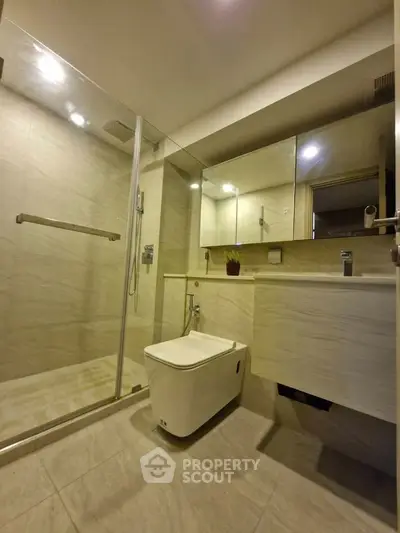 Modern bathroom with sleek design, glass shower, and elegant fixtures in a contemporary home.